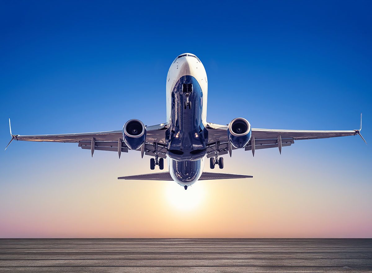 Commercial passenger aircraft taking off at sunrise — aviation safety training for airline cabin crews