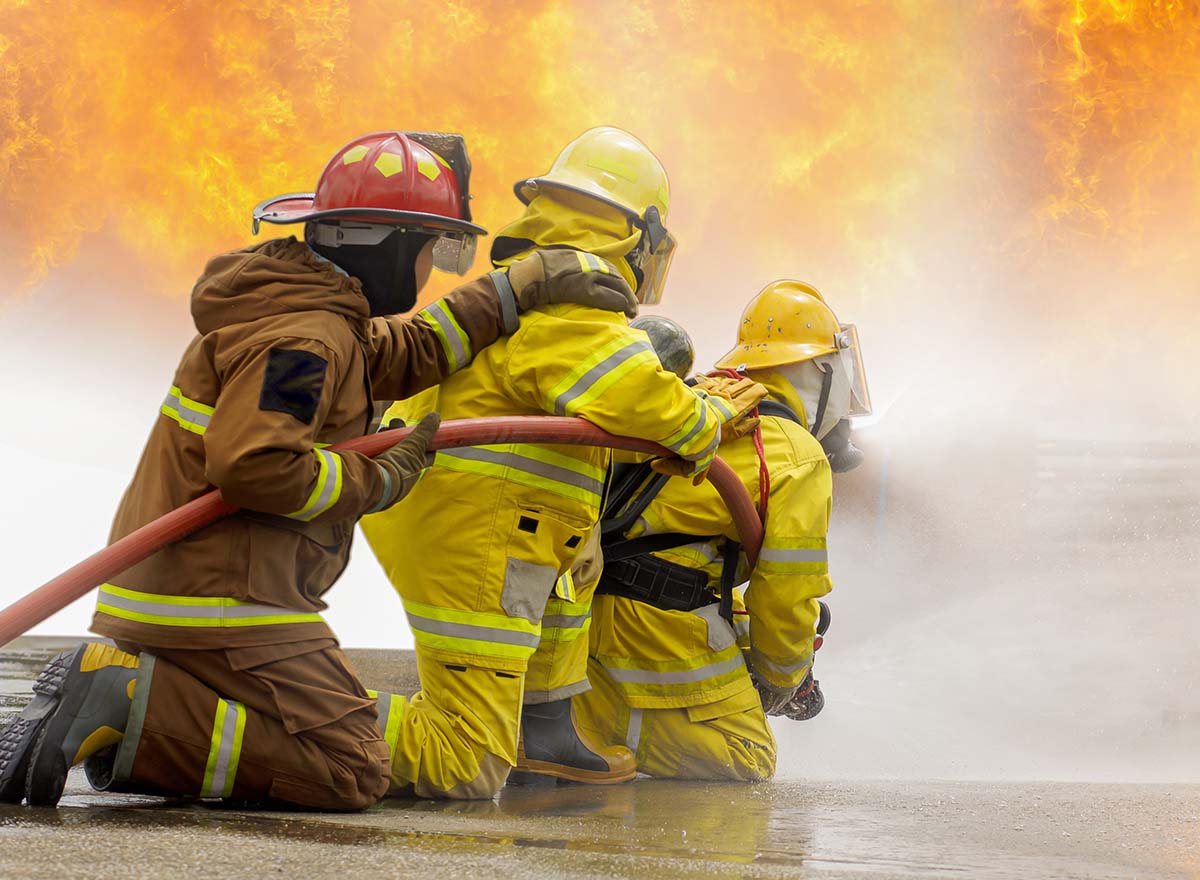 Firefighters in full protective gear responding to an intense fire — emergency response training for safety-critical teams