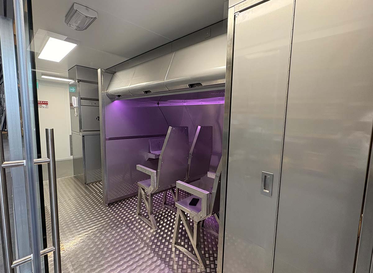 Inside CrewSafety's Real Fire Fighting Airline cabin simulator, the Flame Aviation V7000 Brigade