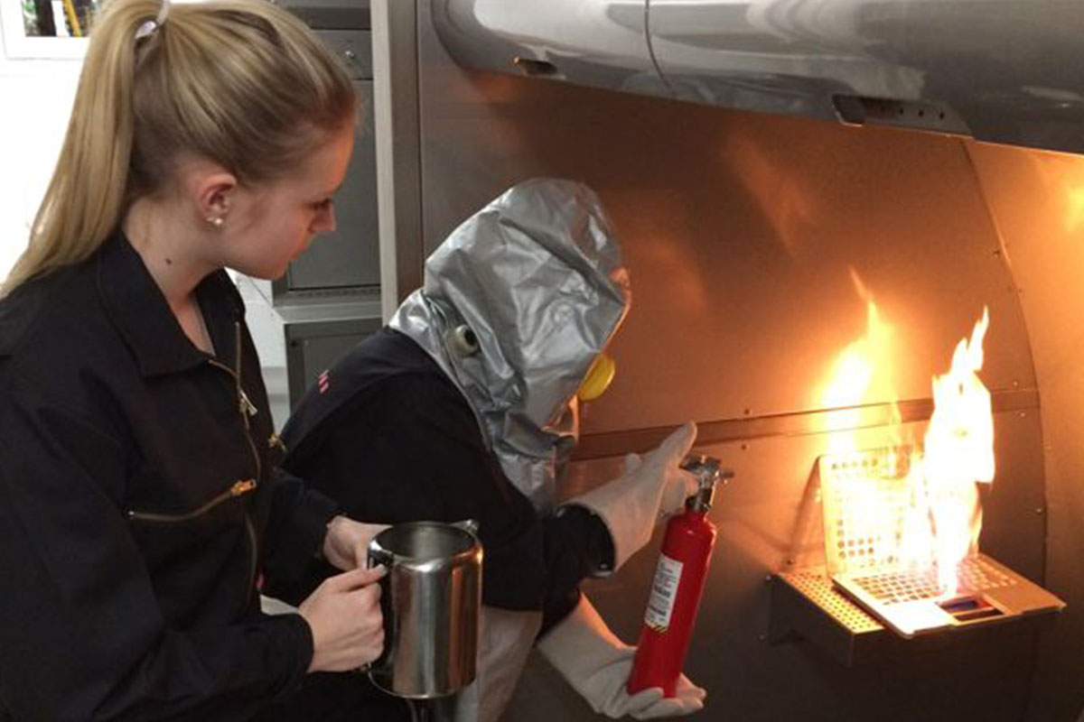 Real firefighter simulator with crew training to extinguish laptop fire onboard plane