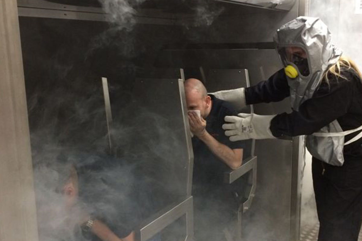 Real firefighter smoke evacuation crew training on jet simulator